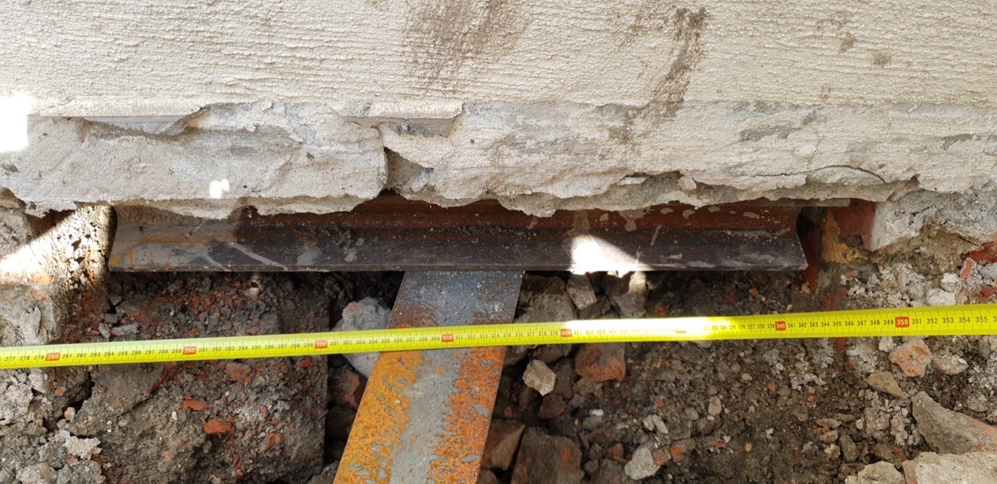 Steel push pier bracket under an existing foundation